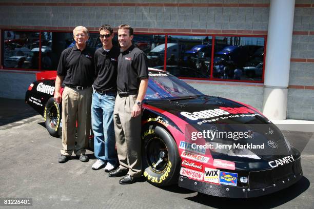 Team owner Joe Gibbs, J.D. Gibbs and Joey Logano, driver of the Gamestop Toyota, stand in front of his new car prior to the NASCAR Nationwide Series...