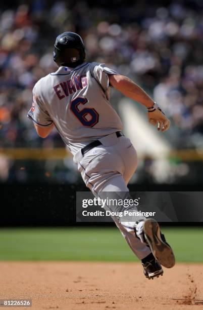 Nick Evans of the New York Mets heads to second with an RBI double against the Colorado Rockies to give the Mets a 7-2 lead in the eighth inning at...