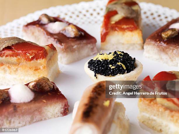 different appetizers with selective focus on caviar cone.  - angel herrero de frutos stock-fotos und bilder