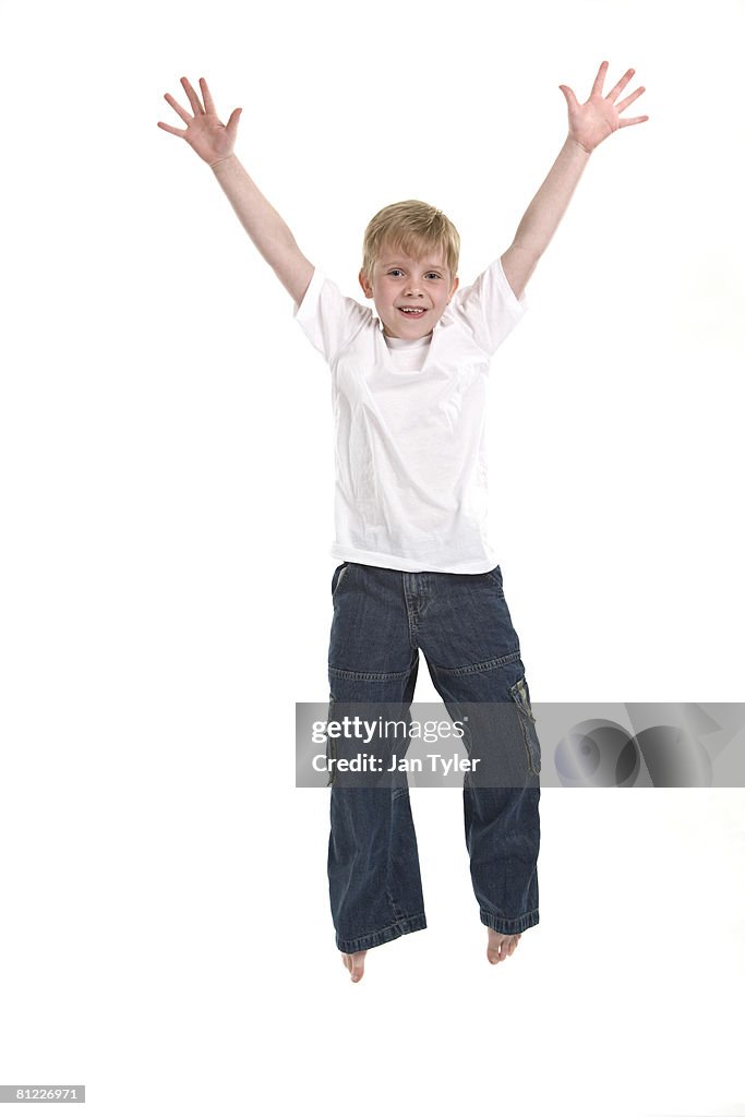 A boy happily jumping in the air.