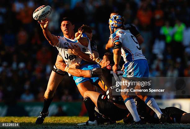 Mark Minichiello of the Titans is tackled during the round 11 NRL match between the Wests Tigers and the Gold Coast Titans at Leichhardt Oval on May...