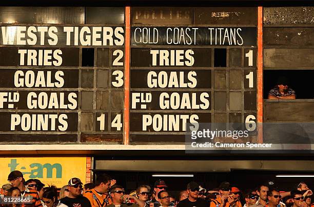 Scoreboard attendant watches the action during the round 11 NRL match between the Wests Tigers and the Gold Coast Titans at Leichhardt Oval on May...