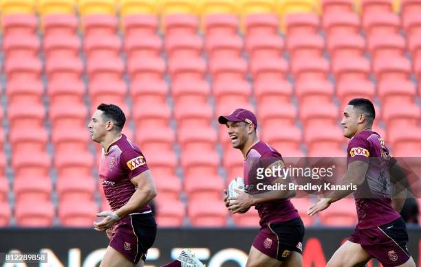Billy Slater is seen running with team mates Will Chambers and Valentine Holmes during a Queensland Maroons State of Origin training session at...