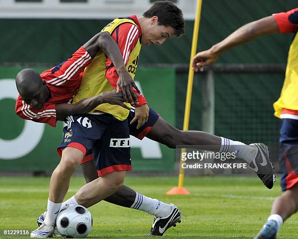 French midfielder Samir Nasri vies with Alou Diarra during a training session in Clairefontaine, southern Paris, on May 23 on the sideline of the...