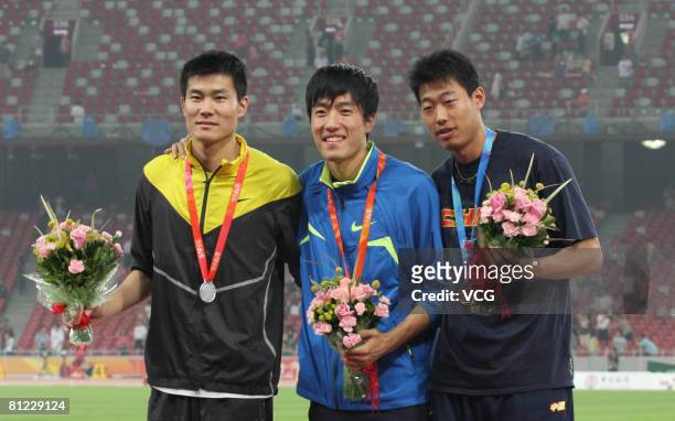 China's world and Olympic champion Liu Xiang with the gold medal, Shi Dongpeng with the silver medal and Ji Wei with the bronze medal for the Men's...