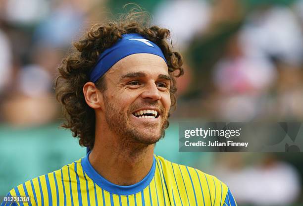 Gustavo Kuerten of Brazil smiles at the fans after his career ending defeat during Men's Singles first round match against Paul-Henri Mathieu of...