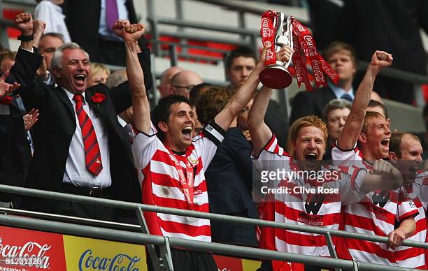 Captain Brian Stock of Doncaster Rovers lifts the trophy as chairman John Ryan celebrates following the Coca Cola League 1 Playoff Final match...