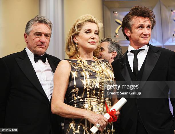 Actor Robert de Niro, actress Catherine Deneuve with her Special Award and jury president Sean Penn during the Palme d'Or Closing Ceremony at the...