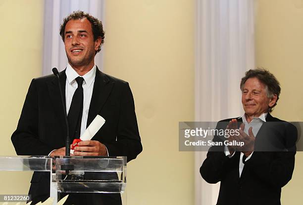 Director Matteo Garrone accepts from Roman Polanski the Grand Prize for the movie 'Gomorra' during the Palme d'Or Closing Ceremony at the Palais des...
