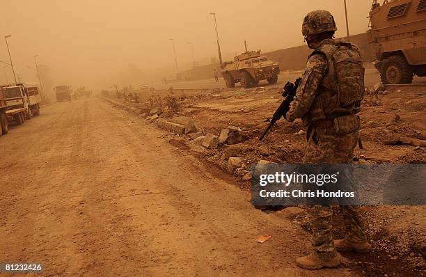 Army soldier of the 3rd Brigade Combat Team of the 4th Infantry Division patrols in a deserted market area, that recently saw heavy fighting, May 25,...