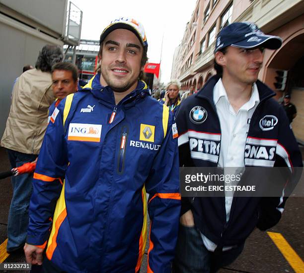 Renault's Spanish driver Fernando Alonso and BMW Sauber's Polish driver Robert Kubica walk in the paddock of the Monaco racetrack on May 25, 2008 in...