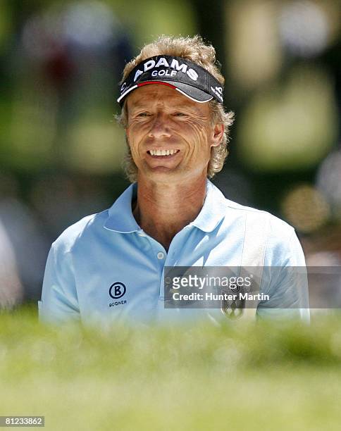 Bernhard Langer of Germany smiles after hitting his third shot on the 4th hole during the final round of the 69th Senior PGA Championship at Oak Hill...