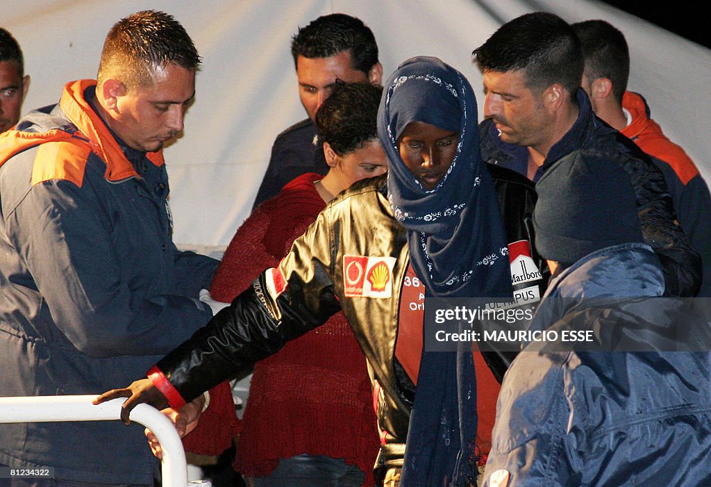 Italian Military navy soldiers help a So