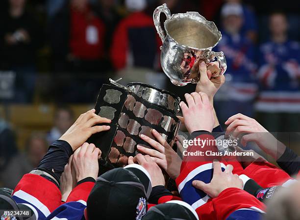 The Spokane Chiefs hoist the shattered Memorial Cup which was dropped in jubilation against the Kitchener Rangers in the Memorial Cup Championship...