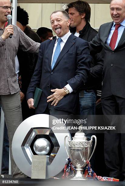 French L1 football team Olympique Lyonnais President Jean-Michel Aulas , flanked by the OL goalkeeper Gregory Coupet, gestures near the club two...