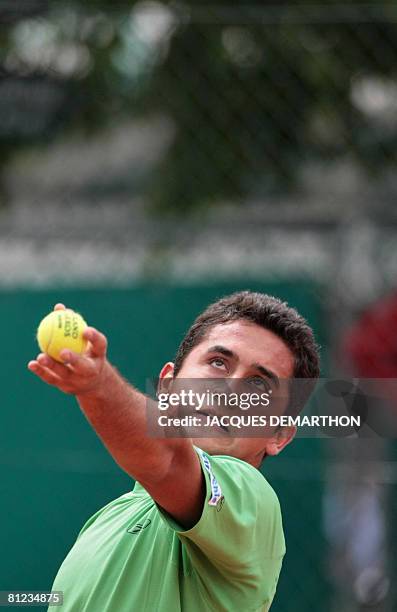 Spanish player Nicolas Almagro serves to his Serbian opponent Boris Pashanski during their tennis Open first round match at Roland Garros, on May 25,...