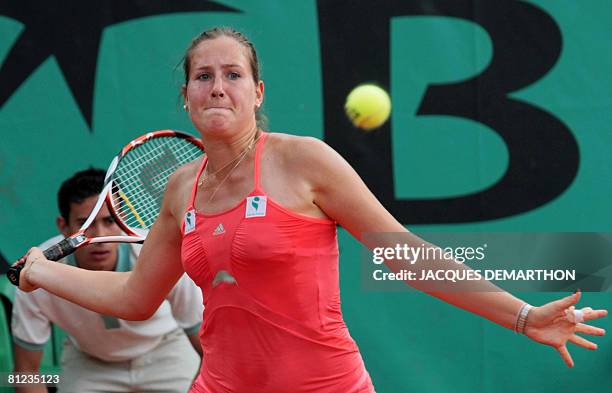 French player Youlia Fedossova eyes the ball for a return to her Russian opponent Galina Voskoboeva during their French tennis Open first round match...