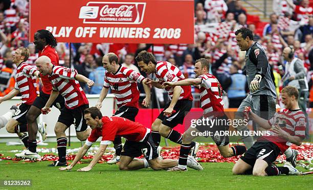 Doncaster Rovers players celebrate their victory over Leeds United during the Football League One playoff final football match at Wembley Stadium in...