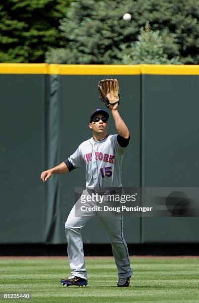 Center fielder Carlos Beltran of the New York Mets catches a fly ball against the Colorado Rockies at Coors Field on May 25, 2008 in Denver,...