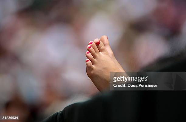 Baseball fan gives her feet a view from the front row during action between the New York Mets and the Colorado Rockies at Coors Field on May 25, 2008...