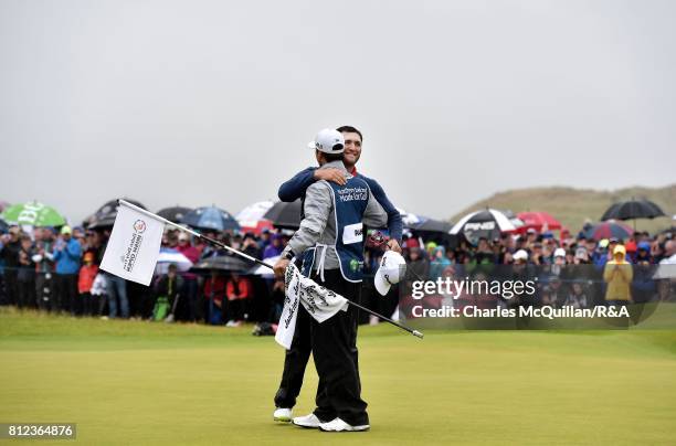 Jon Rahm of Spain hugs his caddy on the 18th green after winning the Dubai Duty Free Irish Open hosted by the Rory Foundation at Portstewart Golf...