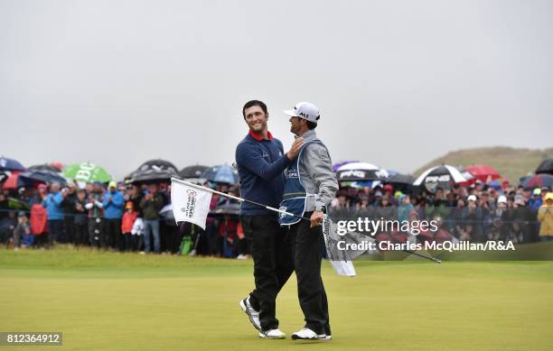 Jon Rahm of Spain hugs his caddy on the 18th green after winning the Dubai Duty Free Irish Open hosted by the Rory Foundation at Portstewart Golf...