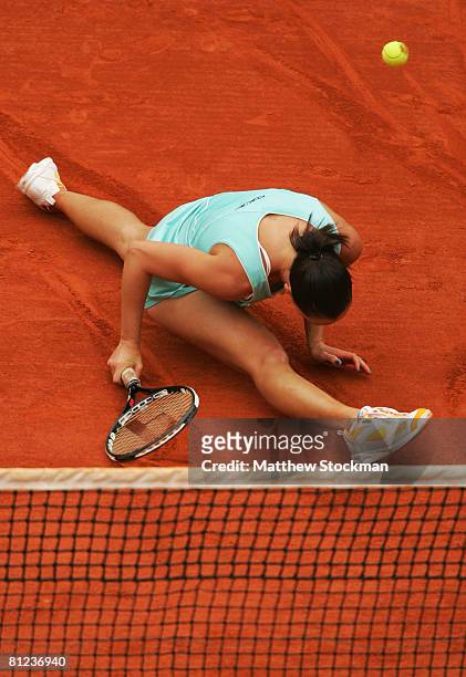 Jelena Jankovic of Serbia misses a shot after sliding to the net during the Women's Singles first round match against Monica Niculescu of Romania on...