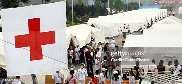 Doctors move an injured earthquake survivor into the field hospital newly built by German Red Cross for China's earthquake victims on May 26, 2008 in...