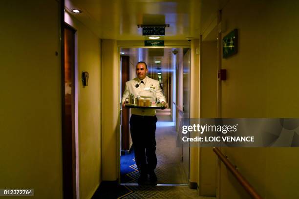 Crew member works aboard the Cunard cruise liner RMS Queen Mary 2, sailing in the Atlantic ocean during the Bridge 2017, a transatlantic race between...