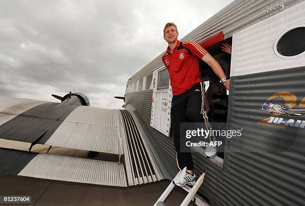 Germany's defender Per Mertesacker disembarks from a JU 52 airplane during a flight around the Balaric island of Majorca on May 25, 2008. The German...