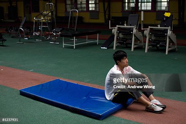 China's Olympic champion 110-meter hurdler Liu Xiang rests during a training session at the National Training Center of China General Administration...