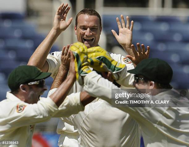 Australia's Stuart Clark celebrates with his team after they get a wicket on West Indies batsman Devon Smith during the 2008 Digicel Home Series at...