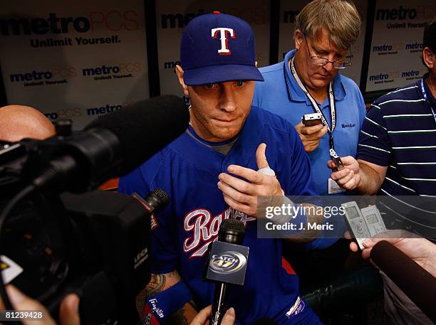 Outfielder Josh Hamilton of the Texas Rangers talks with reporters prior to the game against the Tampa Bay Rays on May 26, 2008 at Tropicana Field in...