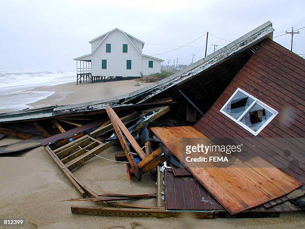 Elevation saves one home, while another collapses, undermined by Hurricane Dennis'' severe beach erosion along Virginia Dare Trail on the Outer Banks...