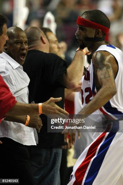 Richard Hamilton of the Detroit Pistons celebrates with a fan after hitting a three pointer against the Boston Celtics during Game Four of the...