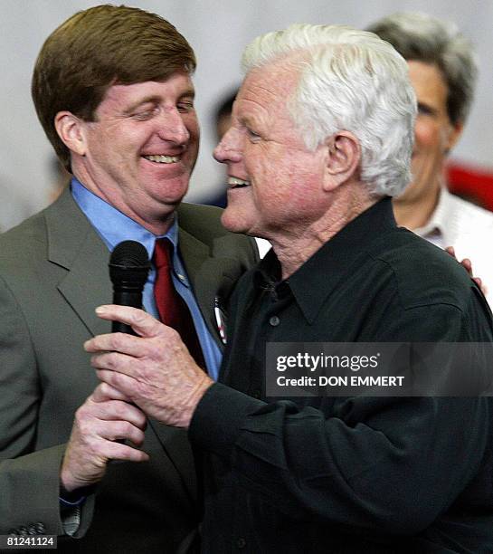 This 25 January 2004 file photo shows US Senator Edward Kennedy of Massachusetts taking the microphone from his son, US Representative Patrick...