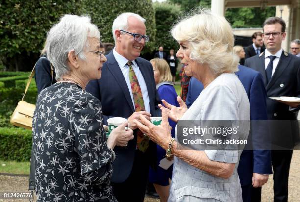 Camilla, Duchess of Cornwall speaks with author Jacqueline Wilson as the Duchess hosts a tea party to celebrate the Duchess's Bookshelves Project at...