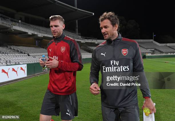 Per Mertesacker of Arsenal chats to Arsenal Coach Jens Lehmann during the Arsenal Training Session at Koragah Oval on July 11, 2017 in Sydney,...
