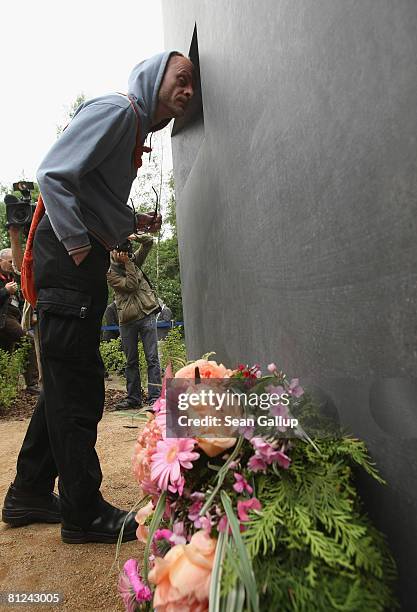 Visitors peeks into the window of the just-inaugurated memorial to homosexual victims of the Nazis on May 27, 2008 in Berlin, Germany. The memorial,...