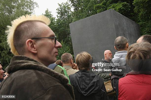 Visitors line up to peek into the window of the just-inaugurated memorial to homosexual victims of the Nazis on May 27, 2008 in Berlin, Germany. The...