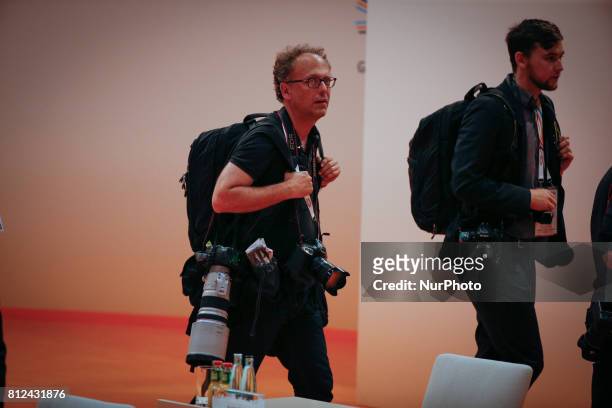 Photographers are seen arriving ahed of the thrid plenary meeting of the G20 summit on 8 July, 2017 in Hamburg, Germany.