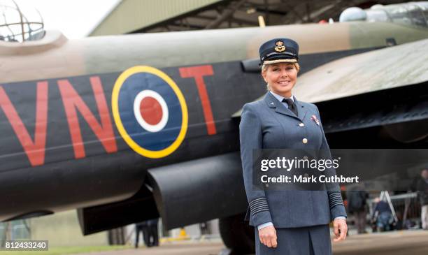 Carol Vorderman poses in front of a Lancaster bomber during a visit to The Battle Of Britain Memorial Flight to mark it's 60th anniversary at RAF...