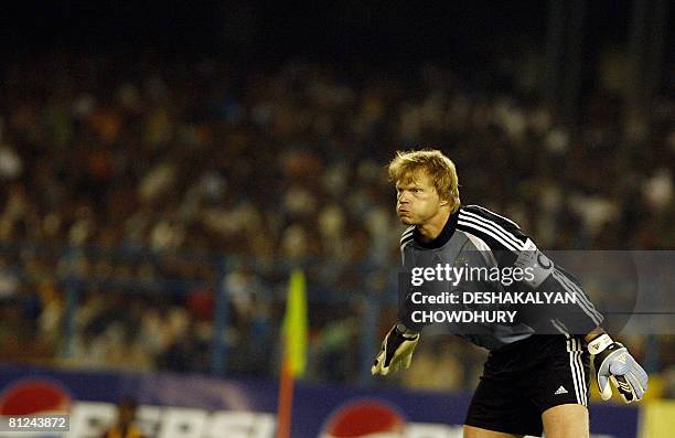 German League and Cup champions Bayern Munich goalkeeper and captain Oliver Kahn eyes the ball during a friendly match between Bayern Munich and...