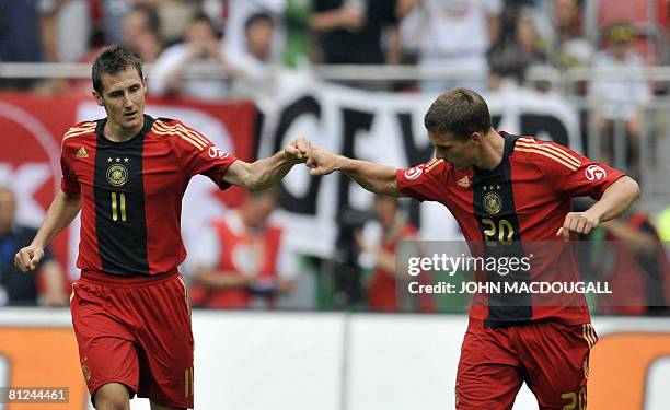 Germany's striker Miroslav Klose and Germany's striker Lukas Podolski celebrate after Klose scored during the Germany vs Belarus international...