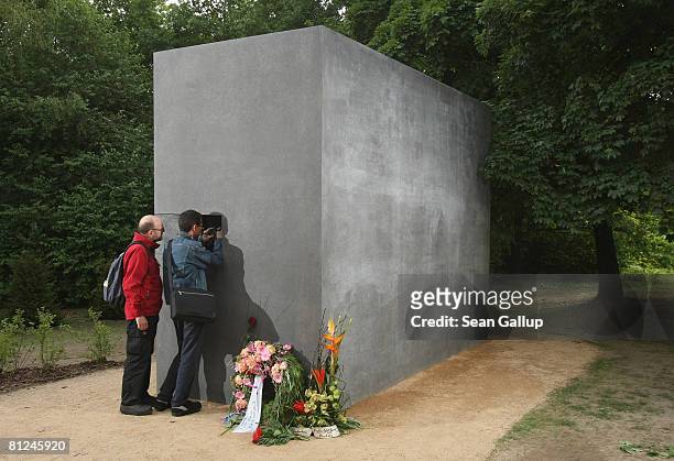 Visitors peek into the window of the newly-inaugurated memorial to homosexual victims of the Nazis on May 27, 2008 in Berlin, Germany. The memorial,...