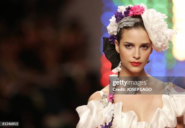 Models present wedding gowns by French designer Christian Lacroix during Barcelona Bridal fashion week on May 27, 2008. AFP PHOTO/JOSEP LAGO.