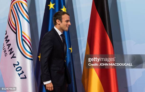 French President Emmanuel Macron arrives for a "retreat meeting" on the first day of the G20 summit in Hamburg, northern Germany, on July 7, 2017. -...