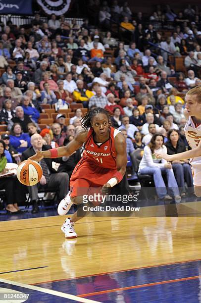 Shannon Johnson of the Houston Comets drives to the basket against Jolene Anderson of the Connecticut Sun during a preseason game at the Mohegan Sun...