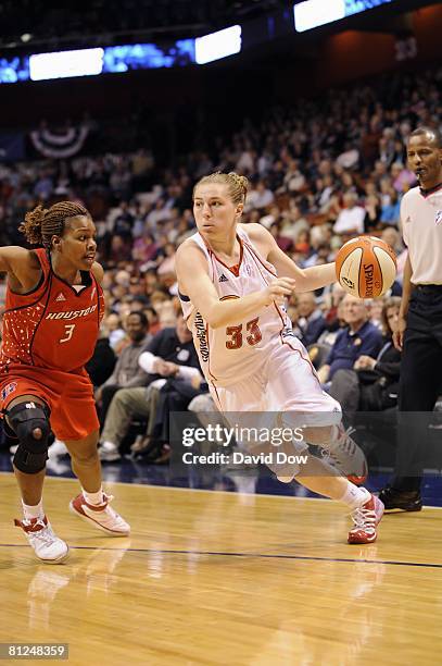 Jolene Anderson of the Connecticut Sun moves the ball against Ashley Shields of the Houston Comets during a preseason game at the Mohegan Sun Arena...