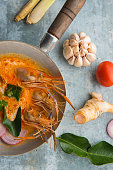 Tom Yum Kung shrimp soup and herb ingredient Thai food with decoration around.